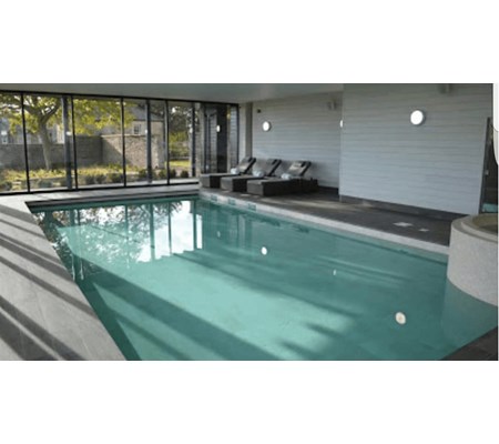Anti-slip Wood effect plank tiles with bespoke nosing pieces. Natural Limestone to Pool Tank.
